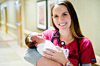 photo of nurse holding baby